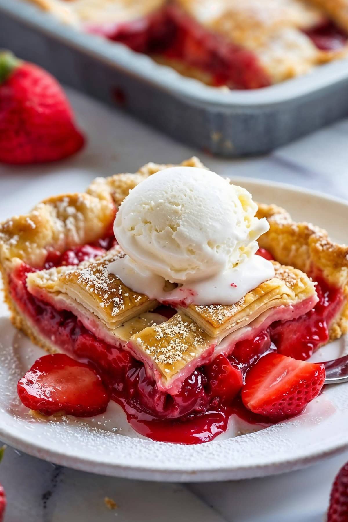 Slice of Strawberry Slab Pie with Vanilla Ice Cream on Top
