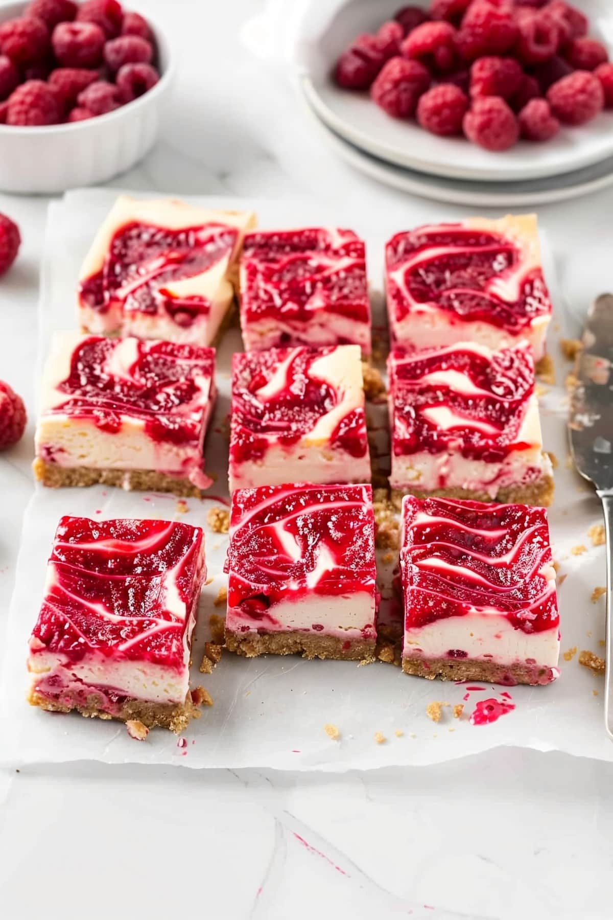 Divine dessert delight: Swirling raspberry cheesecake bars on parchment paper