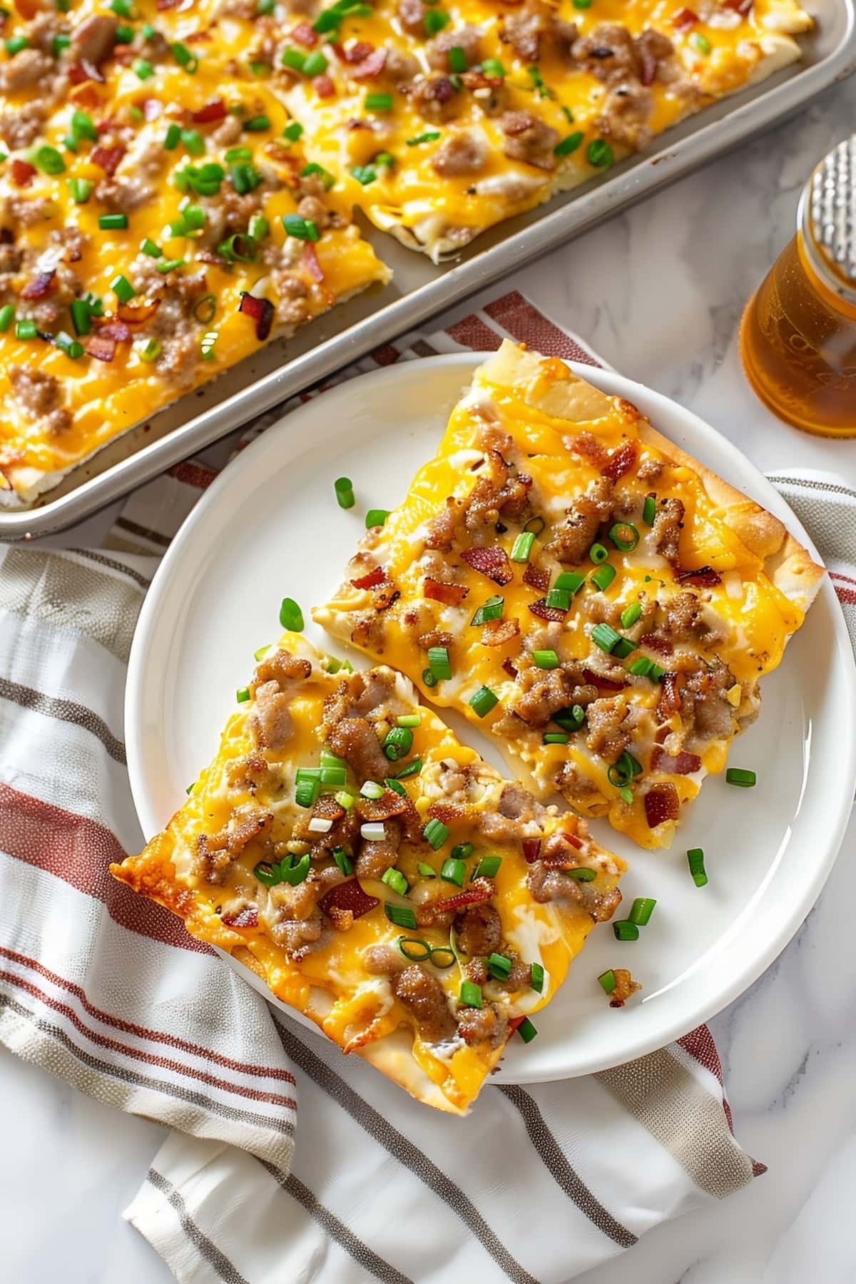 A tempting breakfast pizza loaded with chopped green onions, cheese, bacon and sausage