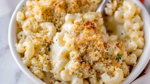 Baked white cheddar mac and cheese with panko crumbs on a white bowl