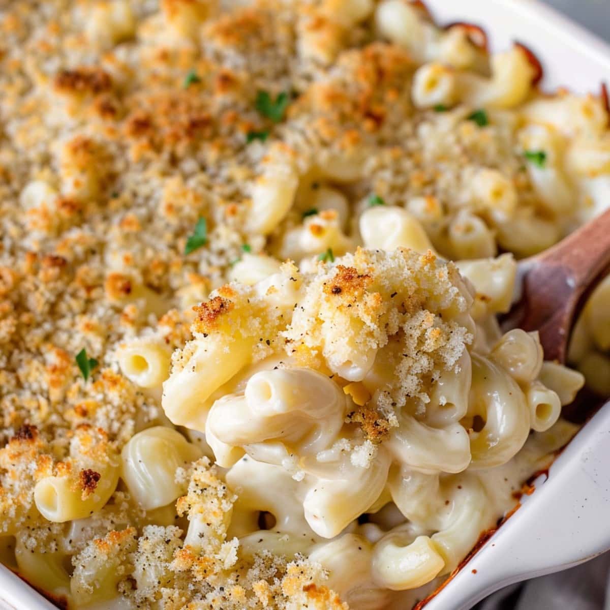 Creamy and cheesy homemade white cheddar mac and cheese in a white casserole