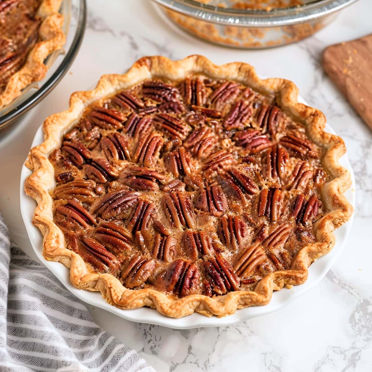 Nutty bourbon pecan pie on a white marble table 
