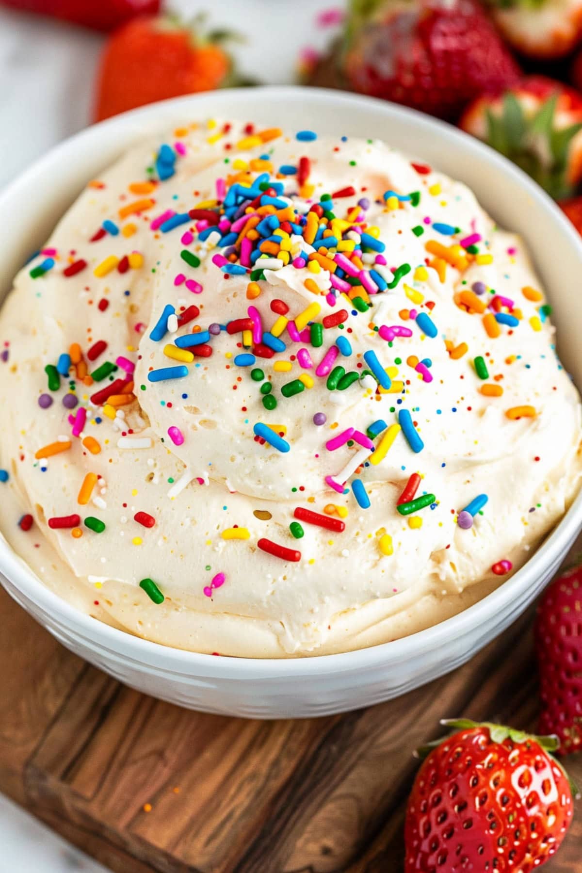 Mouthwatering funfetti cake dip, featuring a creamy base and vibrant sprinkles.