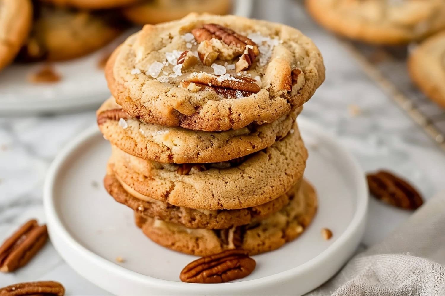 Buttery pecan cookies with sea salt in a white plate