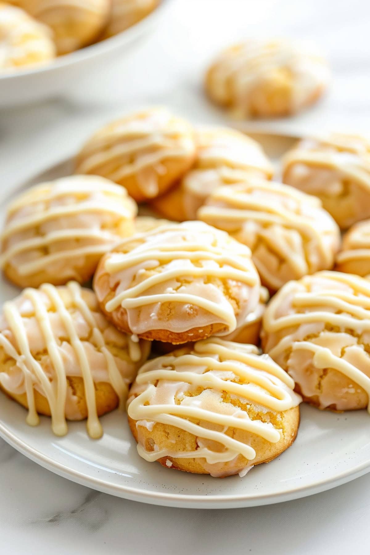 A plate of buttermilk cookies drizzled with buttermilk glaze.