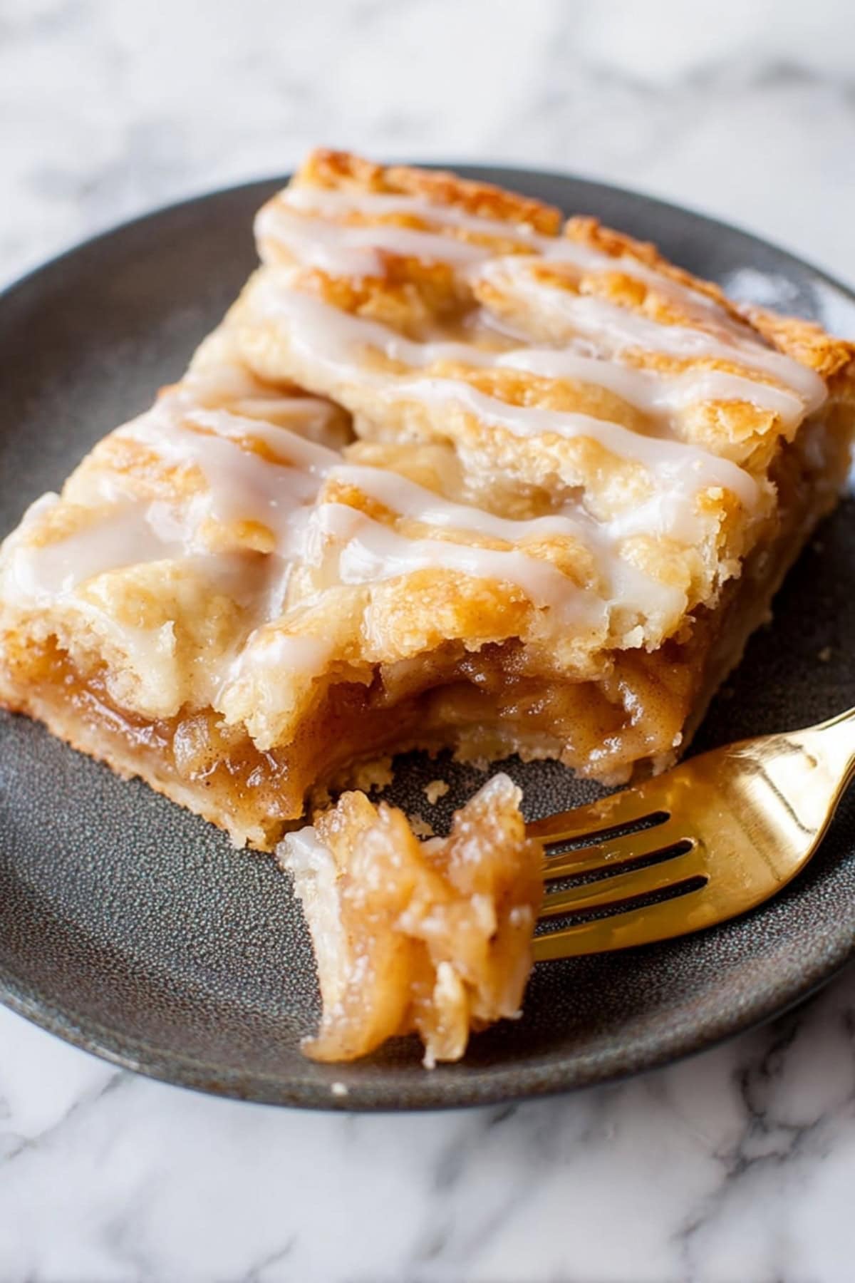 Sliced apple slab pie with glaze in a plate.