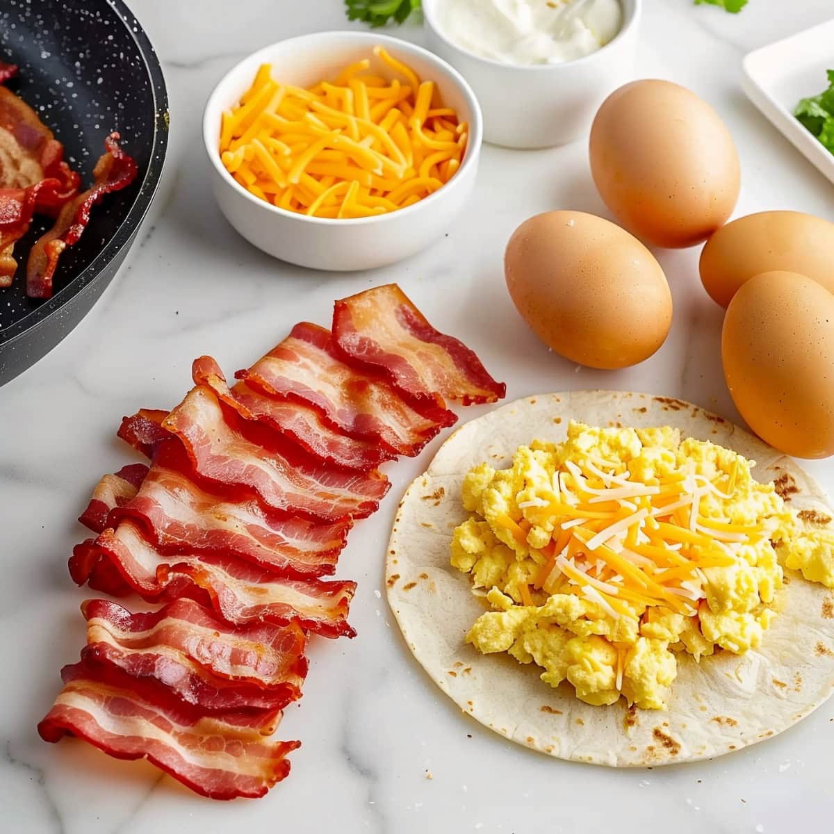 Bacon and breakfast wrap ingredients: Bacon, Scrambled Eggs and Cheese.