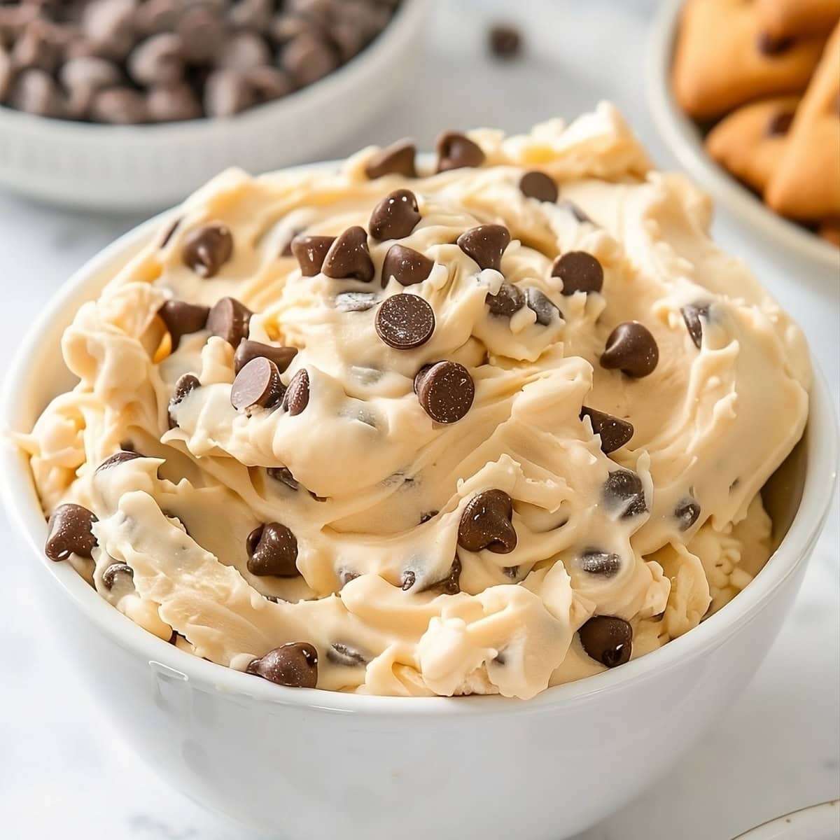 Chocolate chip cookie dough dip in a white bowl.