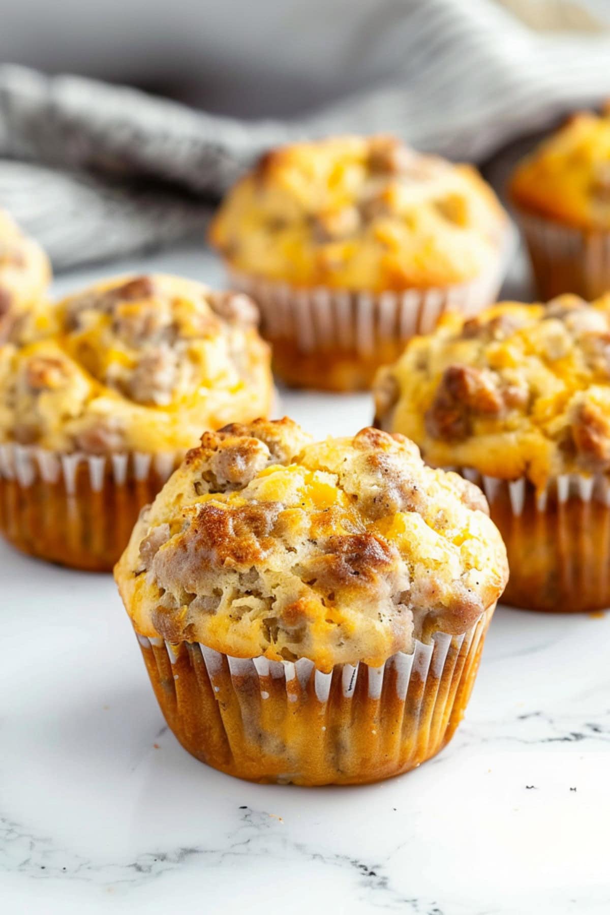 Appetizing breakfast sausage muffins on a white marble countertop