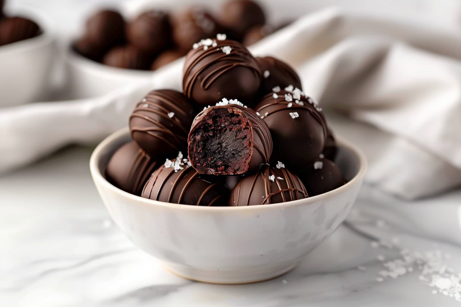 Delicious brownie truffles, dipped in melted chocolate and garnished with a sprinkle of sea salt