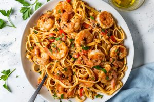 Homemade Cajun shrimp pasta, tossed with bell peppers and garnished with parsley