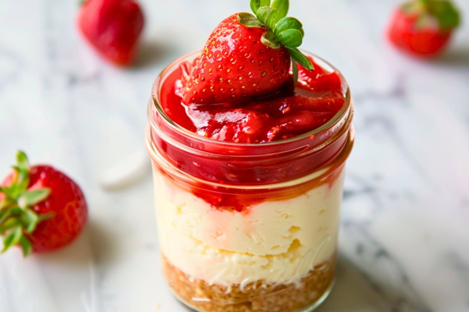 Cheesecake in jar with fresh strawberry.