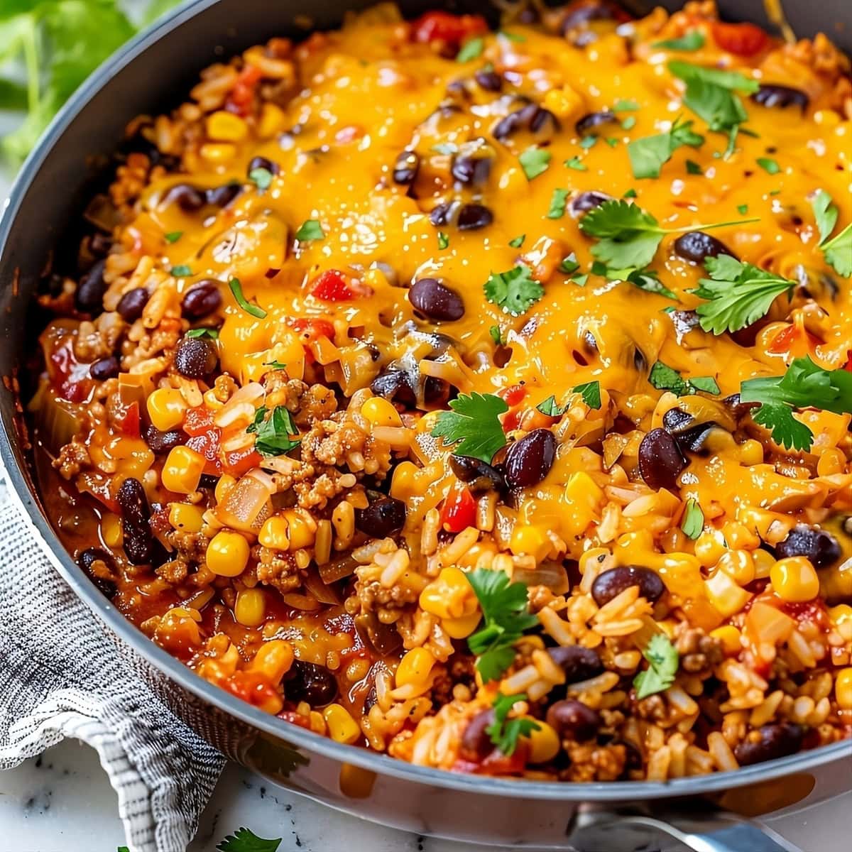 Cheesy Mexican rice casserole in skillet.