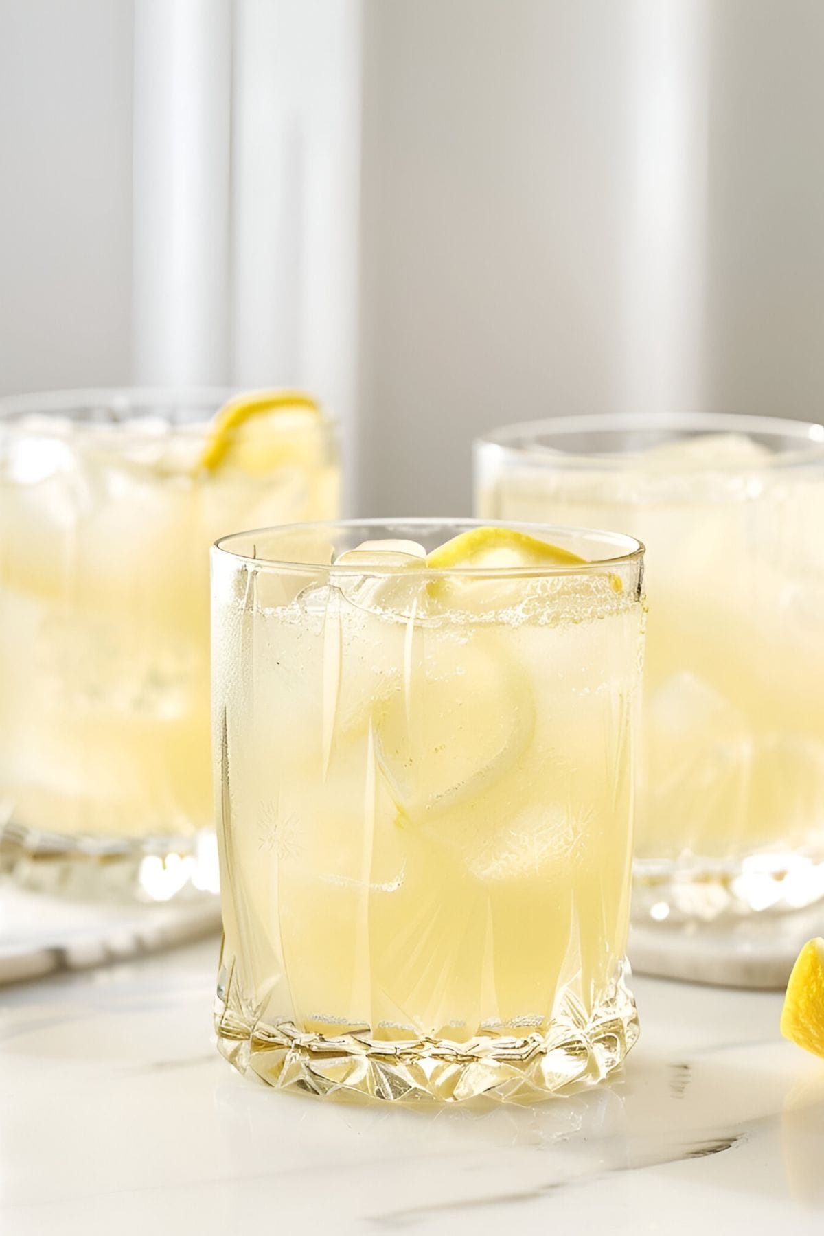 Three Glasses of Chick-Fil-A Lemonade with Ice and Slices of Lemon