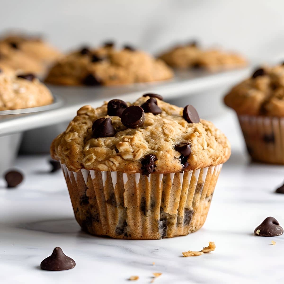 Close up of Chocolate Chip Oatmeal Muffin on a White Marble Table