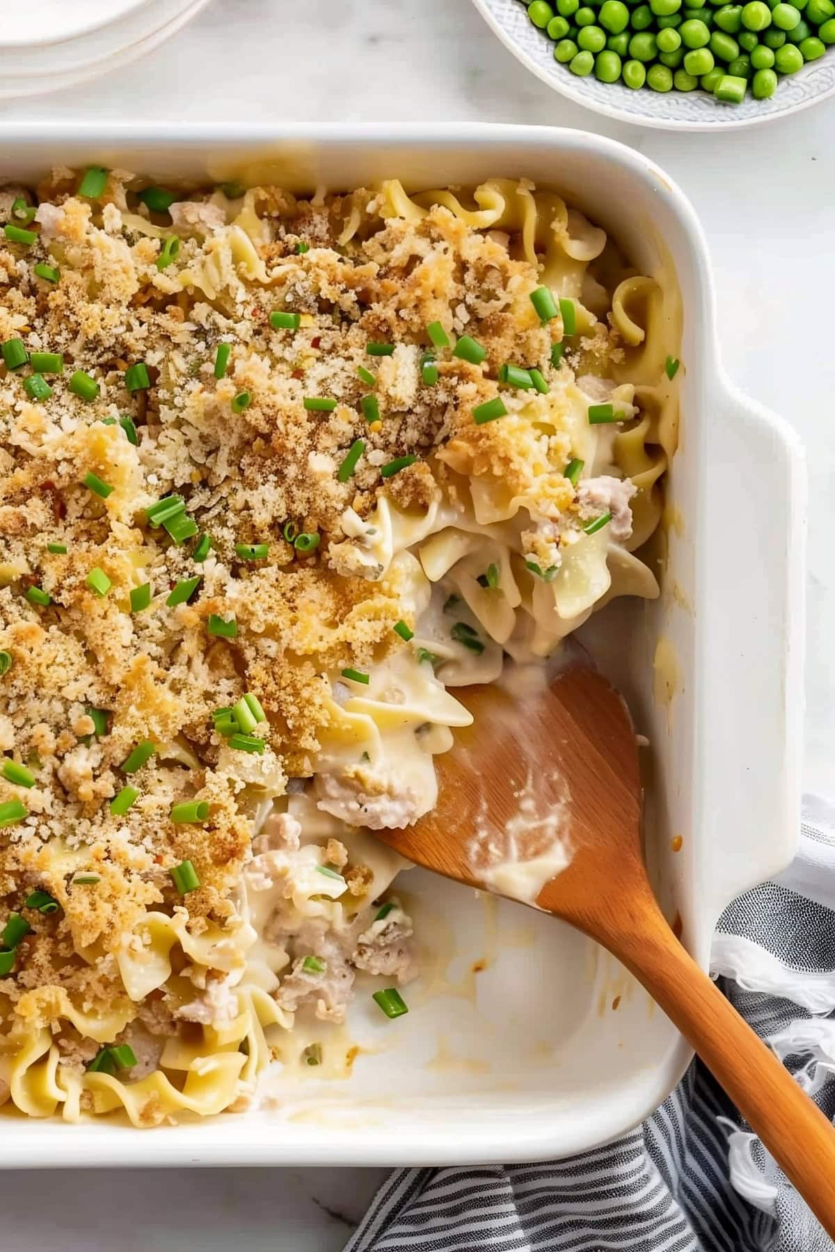A baking dish filled with creamy tuna noodle casserole fresh out of the oven.