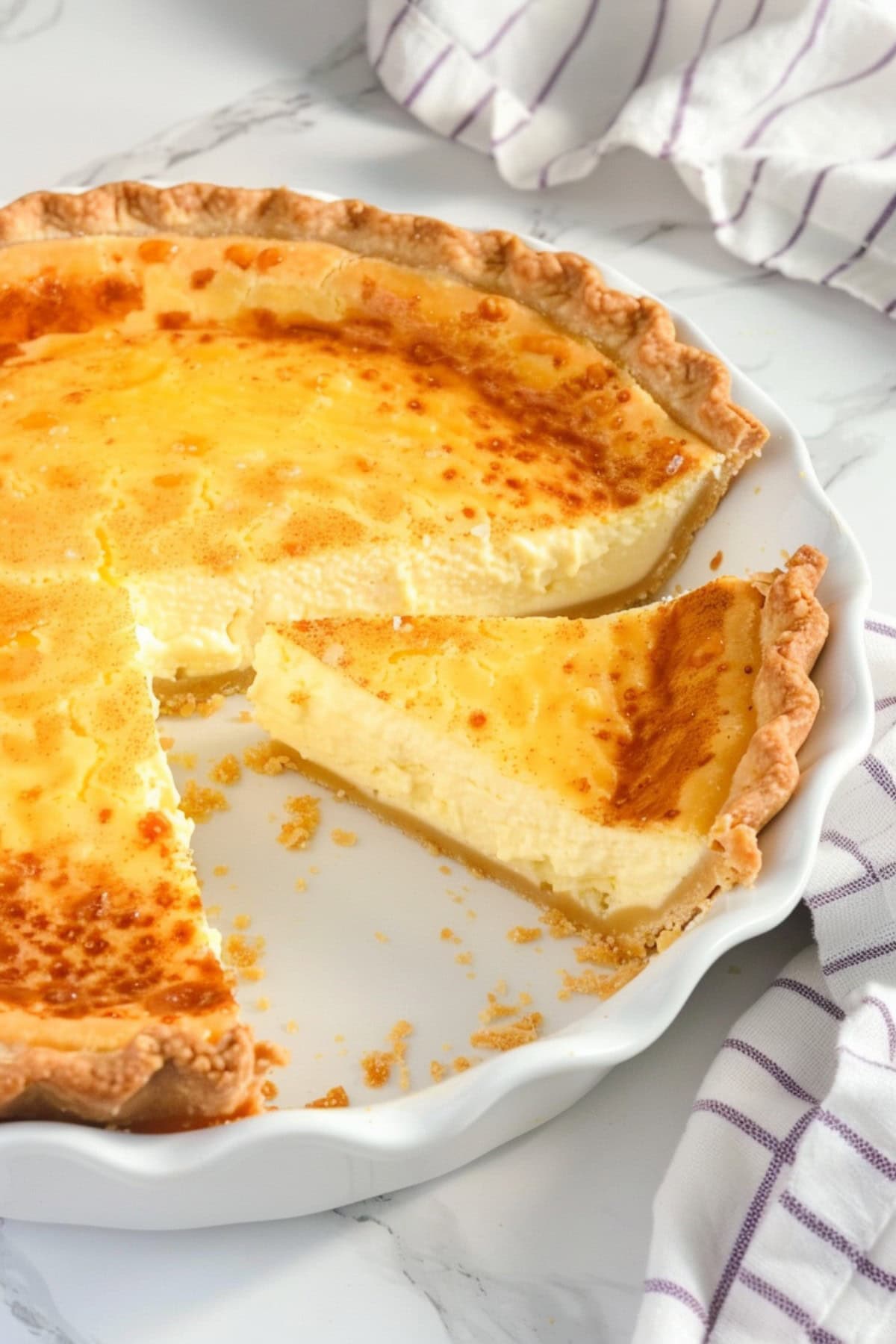 Indulgent custard pie with a flaky crust, ready to be sliced