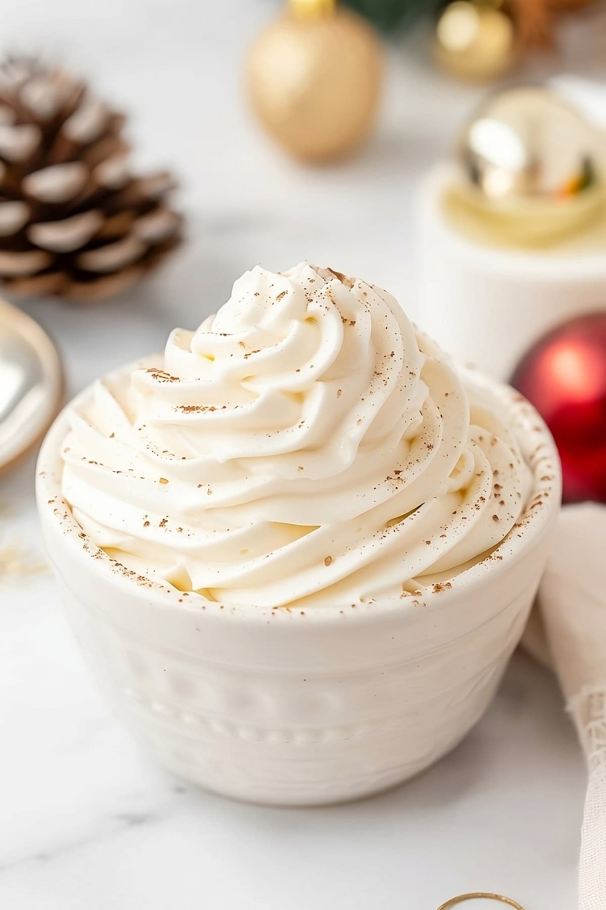 Eggnog whipped cream in a white bowl.