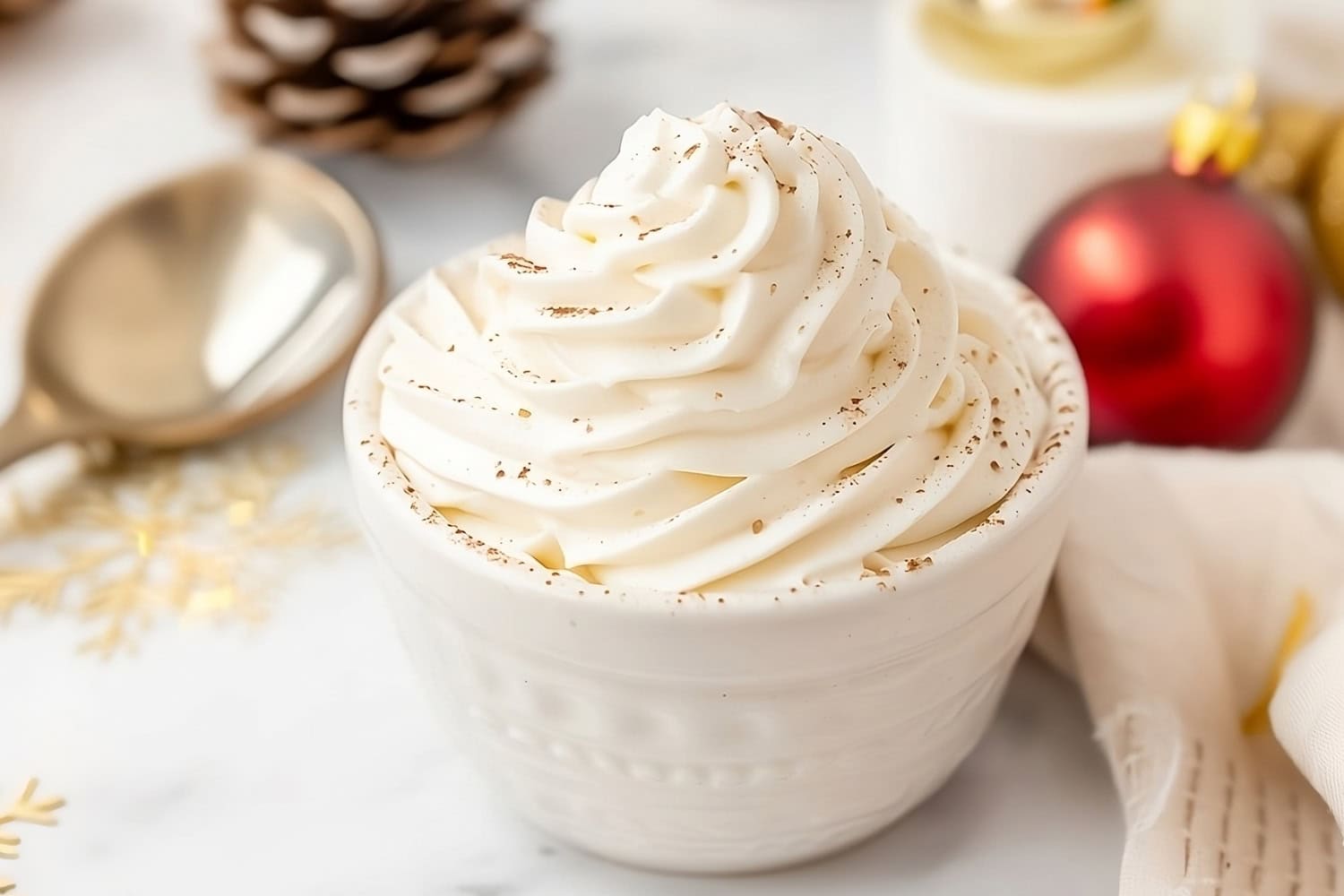 Eggnog whipped cream in a white bowl in an autumn decorated table.