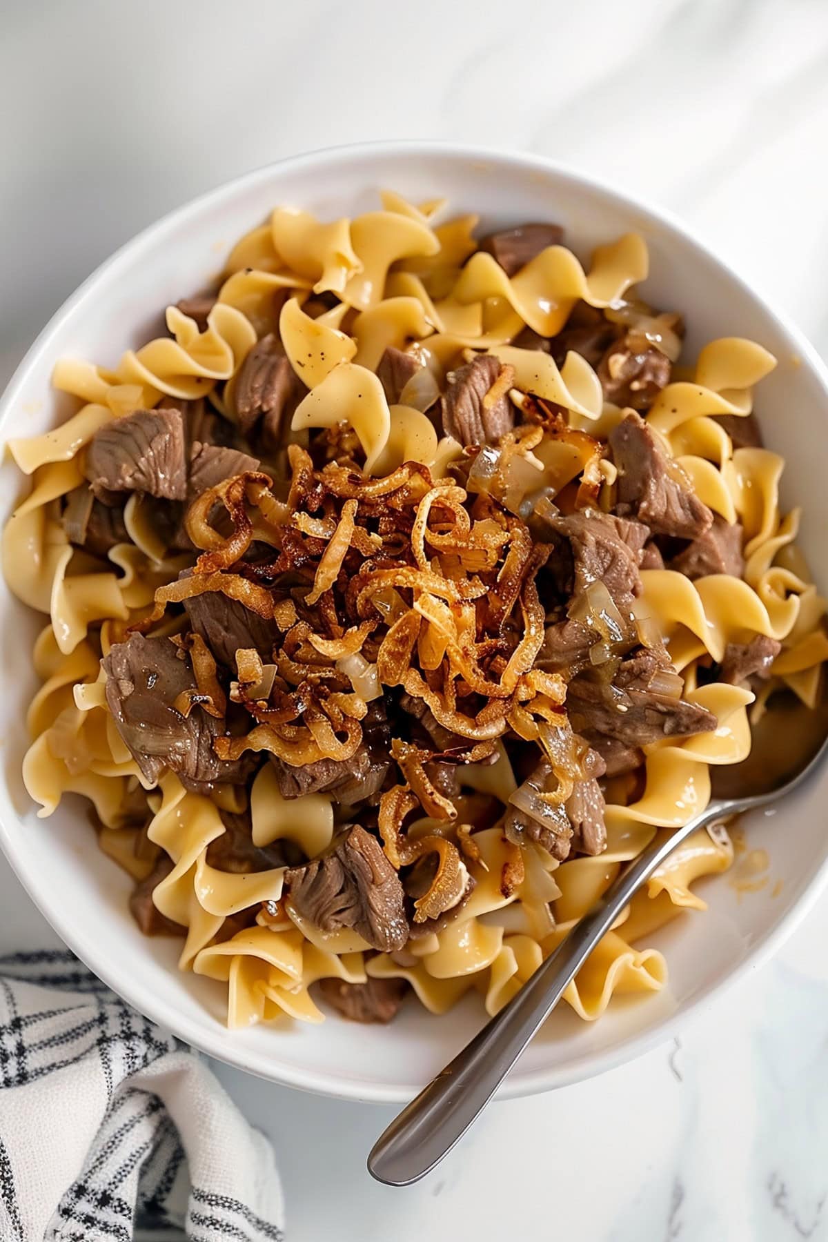 Hearty homemade French onion beef and noodles with caramelized and crispy onions