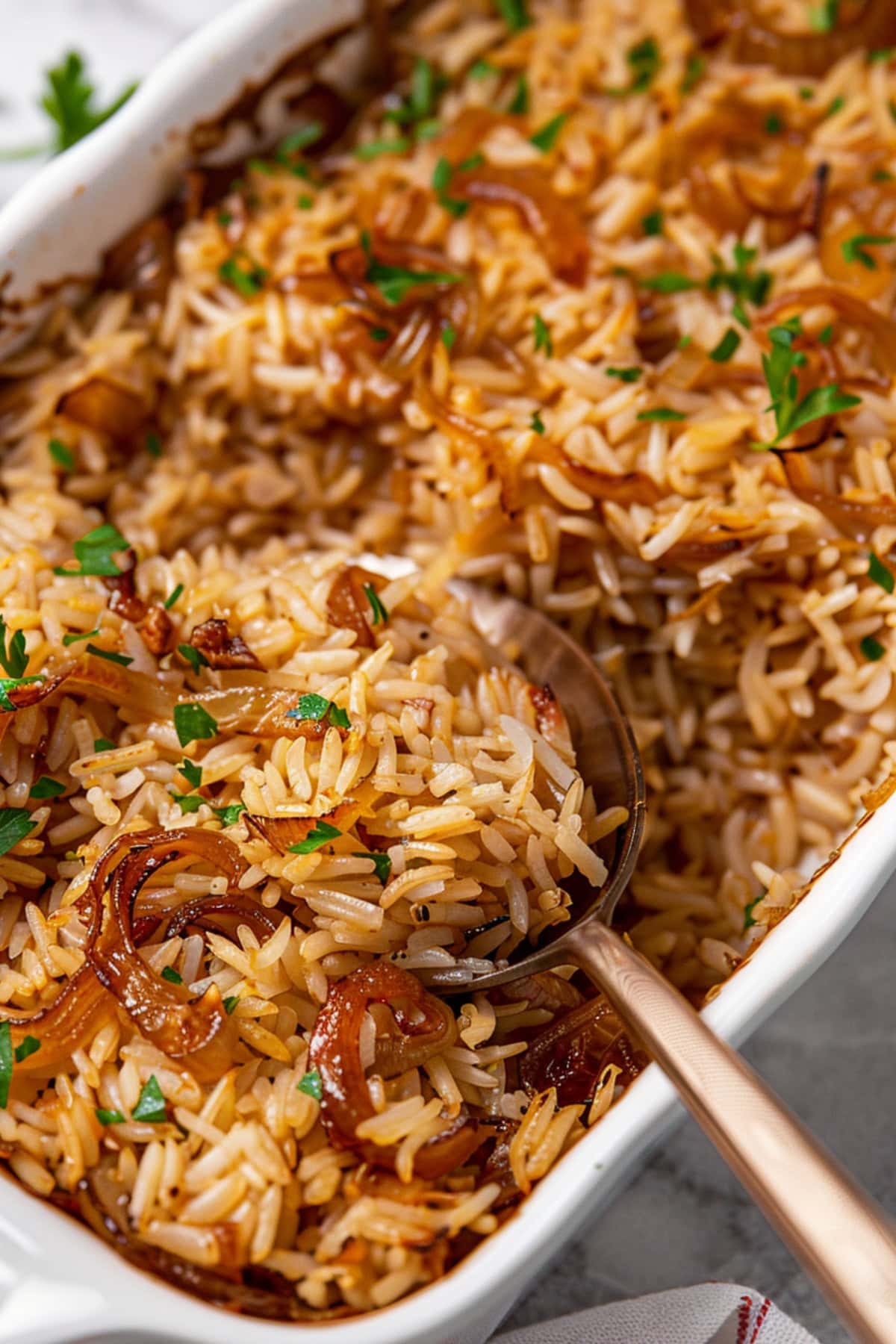 Baked French onion rice in a white baking dish.