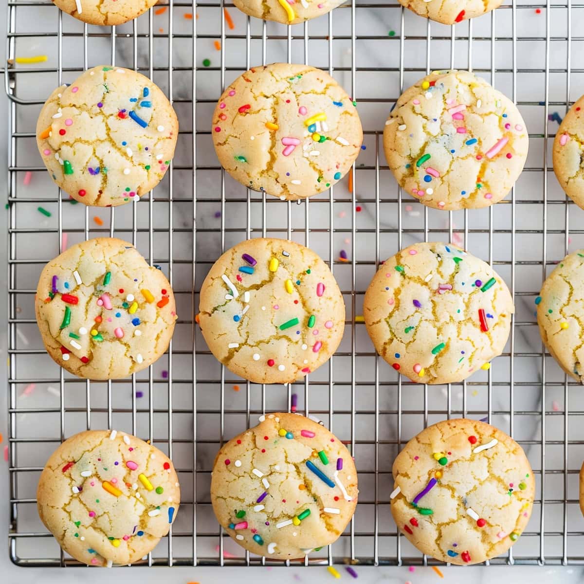Overhead view of chewy funfetti cake mix cookies on a wire rack