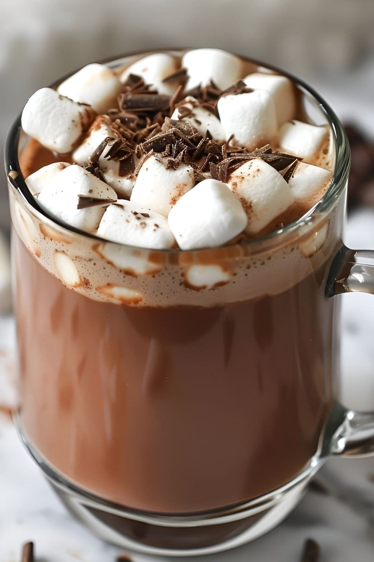 Close Up Semi Top View of Glass Mug of Ghiradelli Hot Chocolate with Marshmallows and Chocolate Shavings
