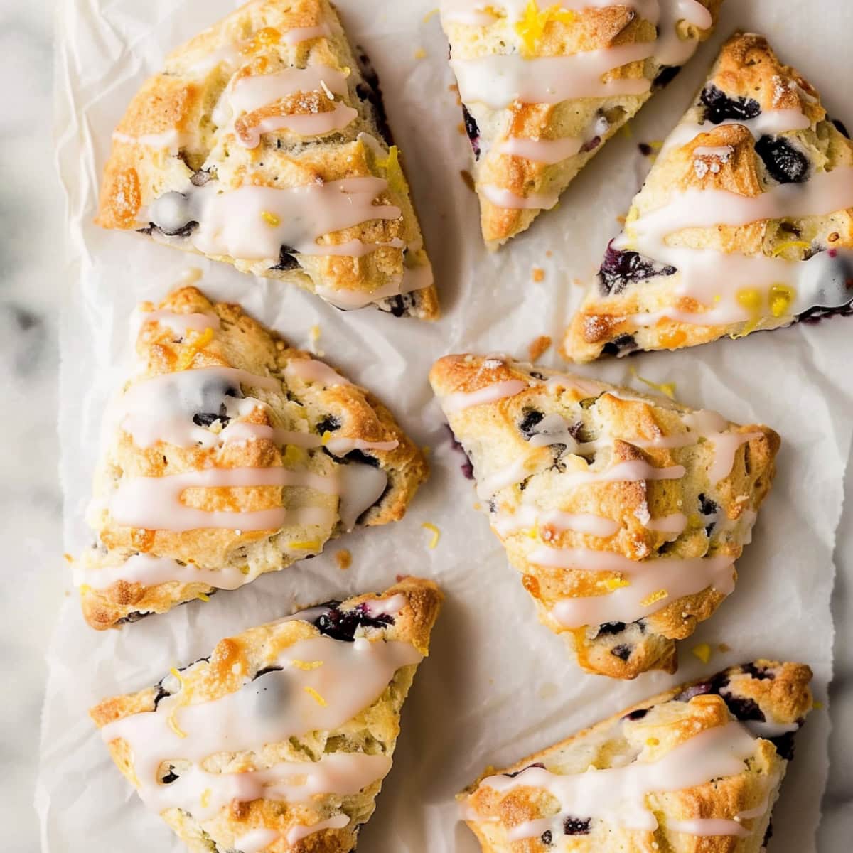Comforting glazed lemon blueberry scones, ideal for breakfast or brunch, with a refreshing citrus aroma.