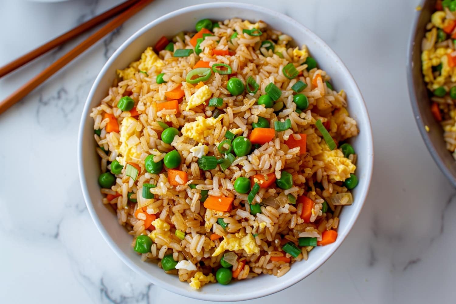 Mouthwatering hibachi fried rice filled with egg, green peas, carrots and green onions
