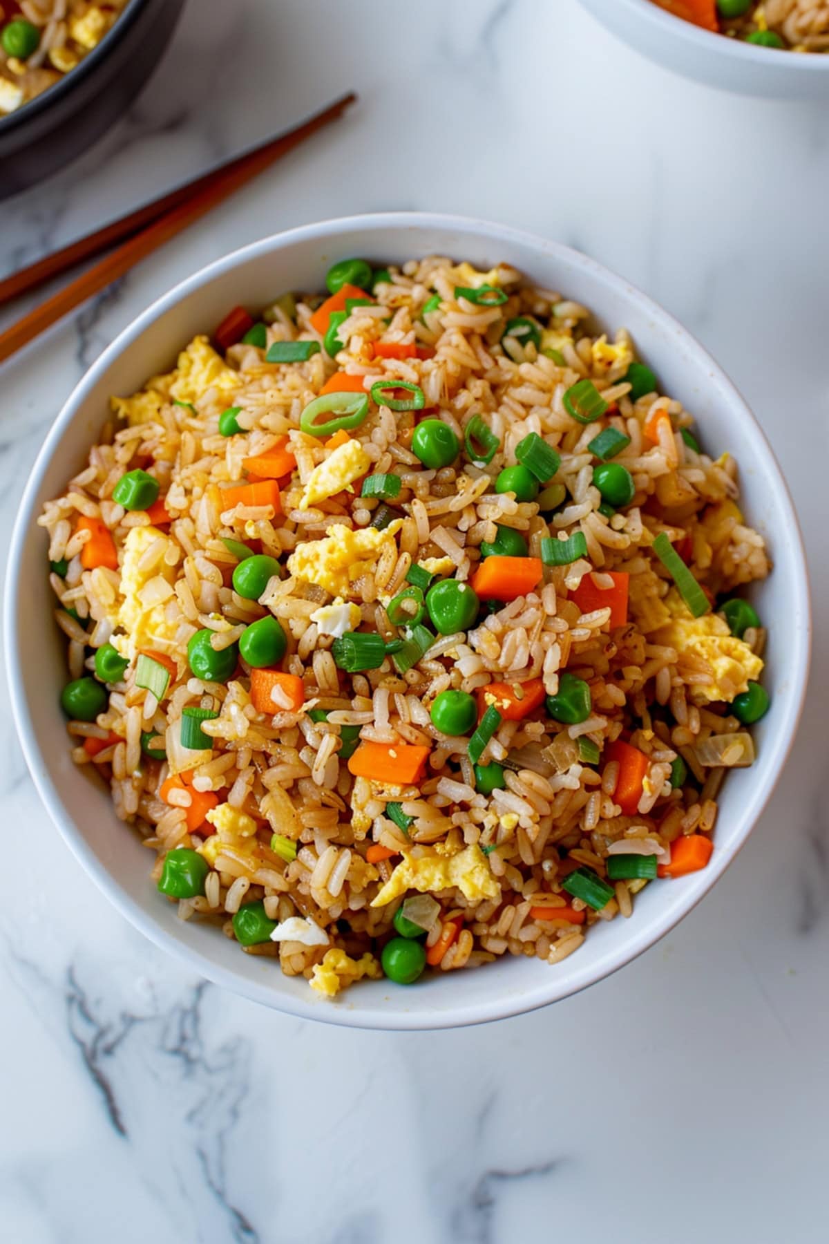 Homemade hibachi fried rice with egg, green peas, carrots, and green onions