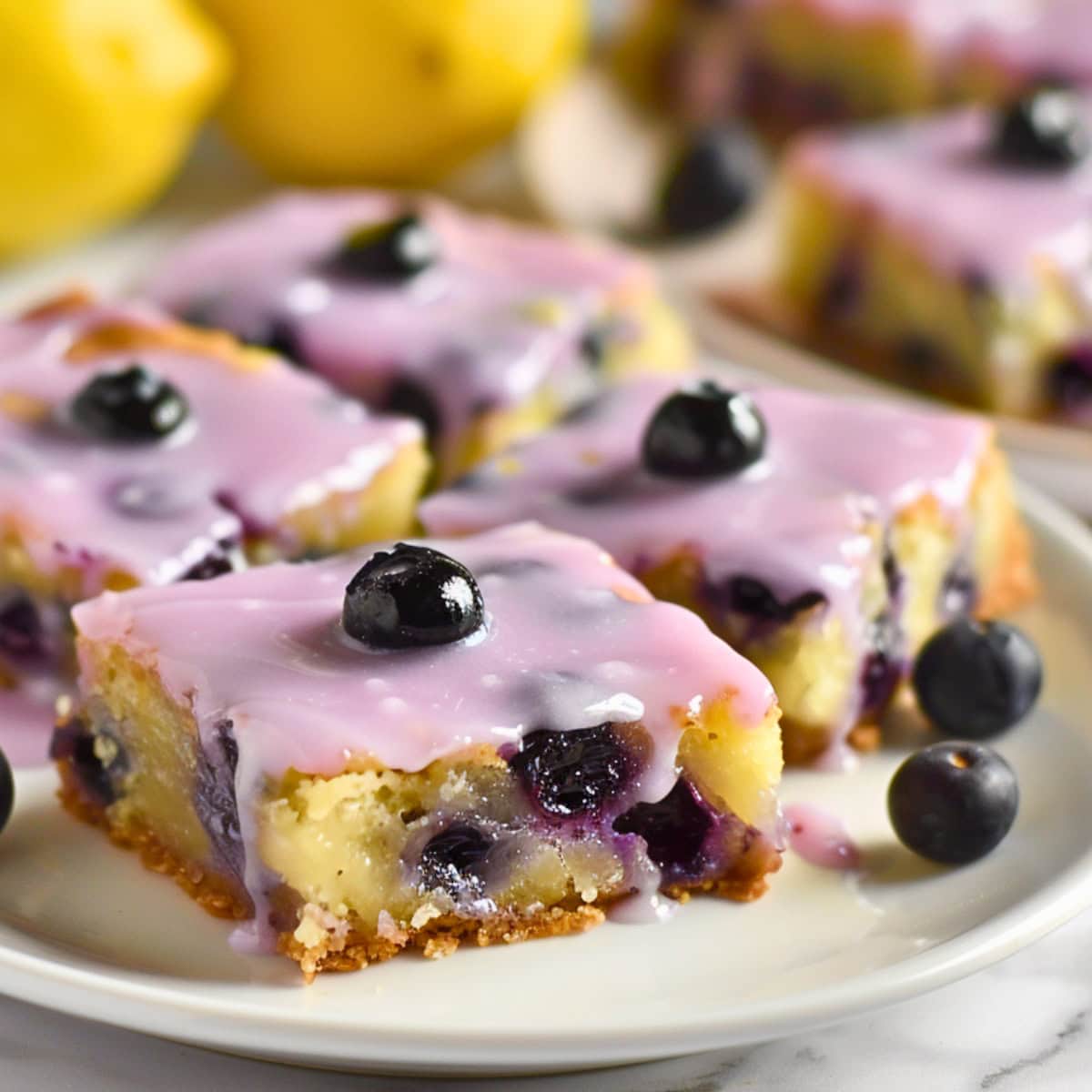 Square slices of lemon blueberry blondies in plate.