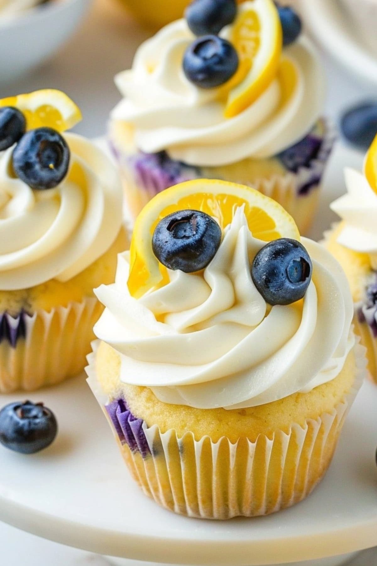 Lemon blueberry cupcakes arranged in cake tray.