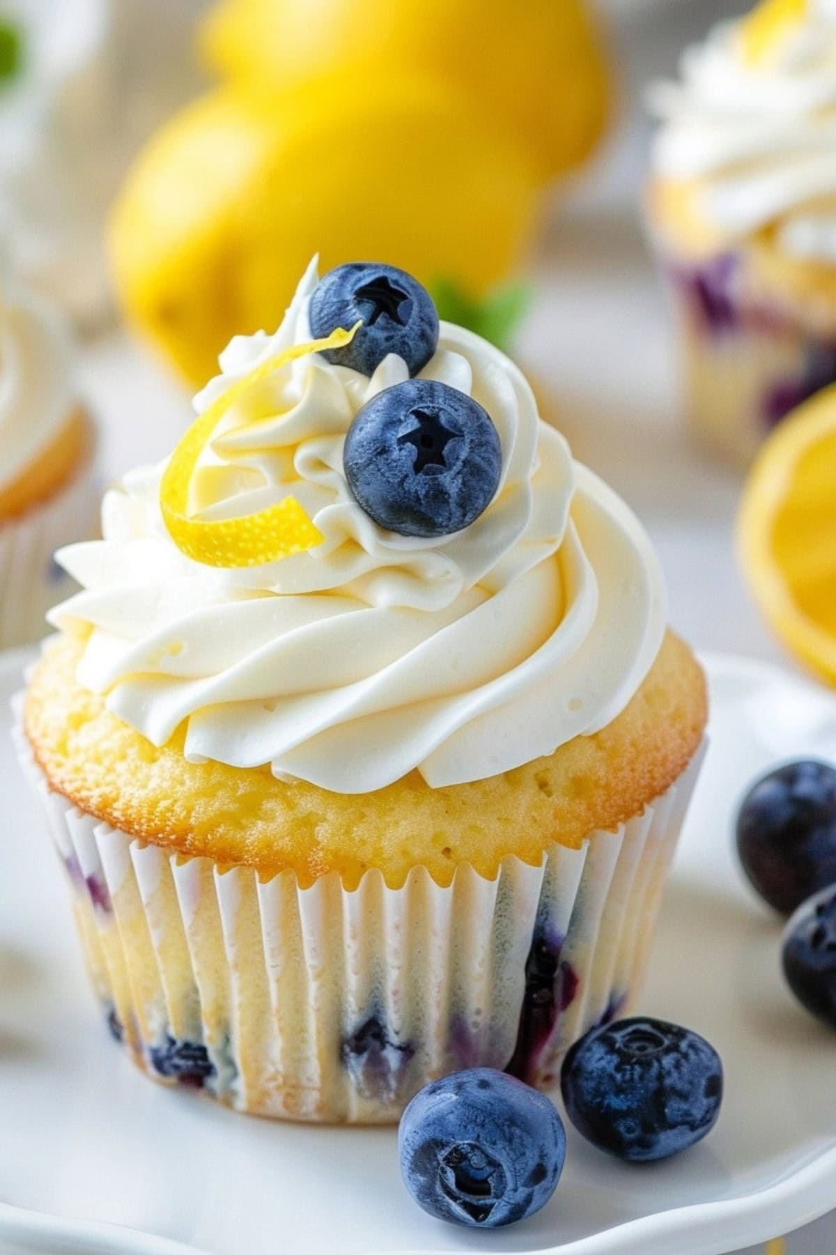 Cupcake with blueberries garnished with buttercream frosting.