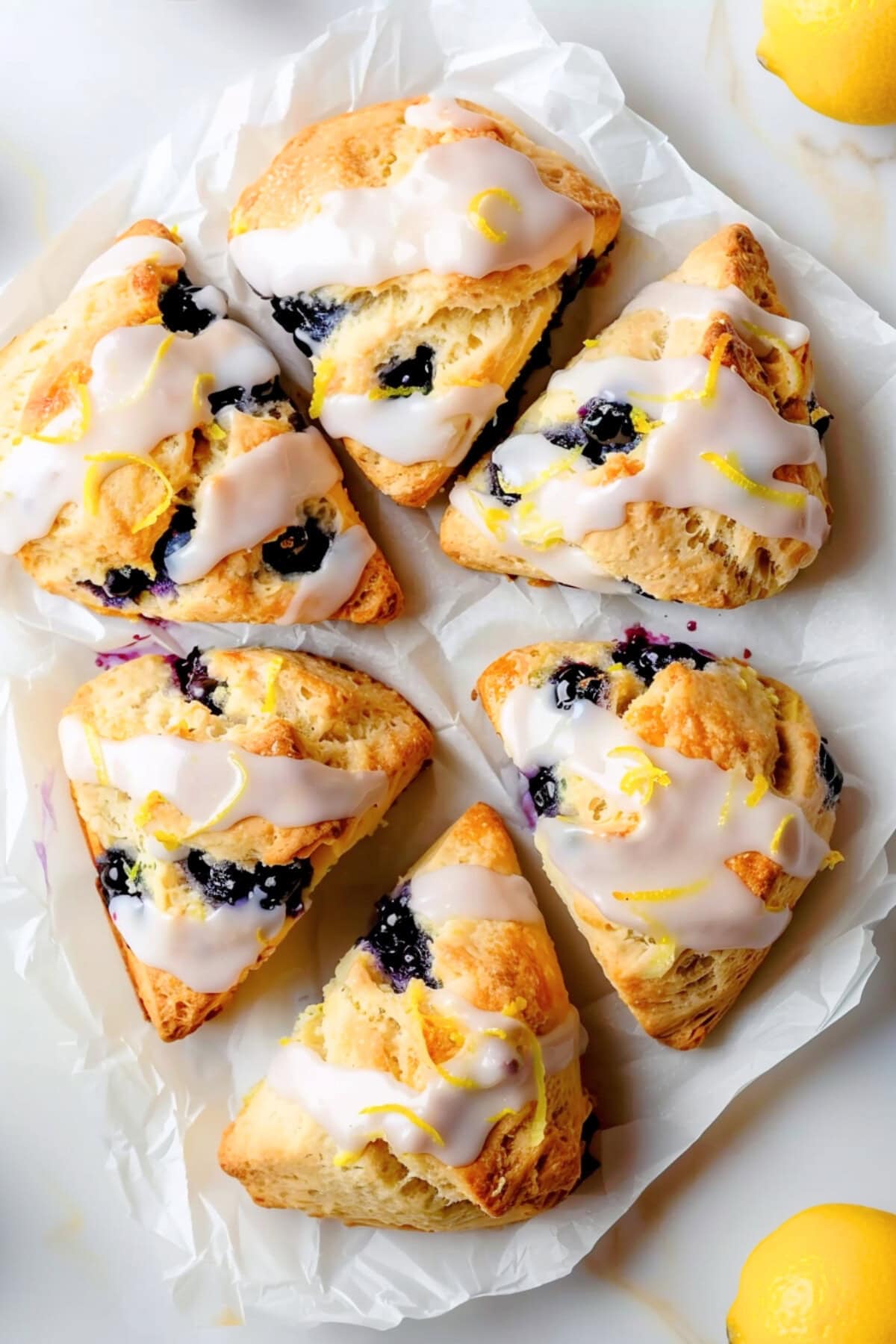 Juicy and flavorful homemade glazed lemon blueberry scones.