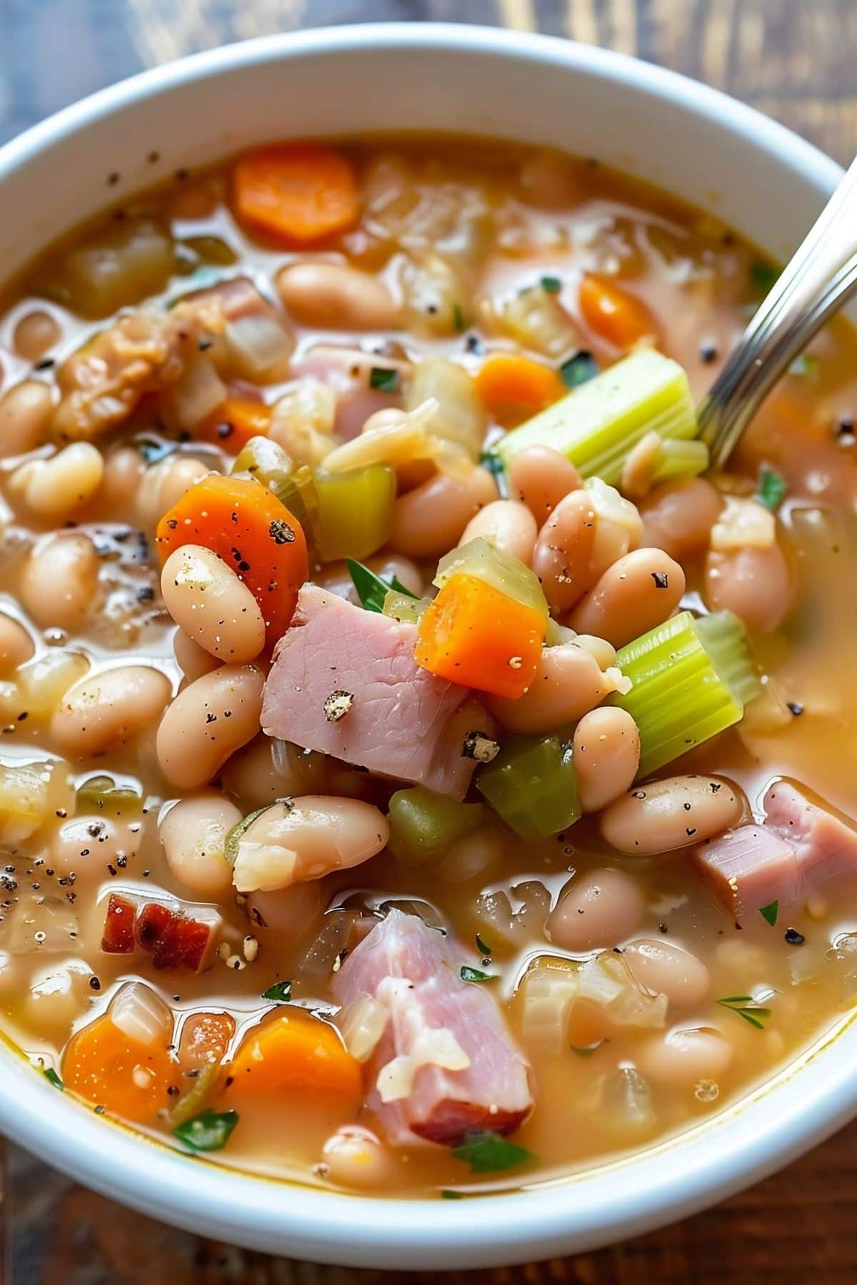 Close Up of Old-Fashioned Ham and Bean Soup in a Bowl with a Spoon
