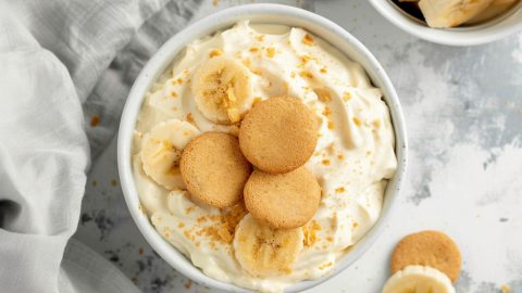 A close-up shot of banana pudding dip highlighting the creamy consistency with three vanilla wafers on top