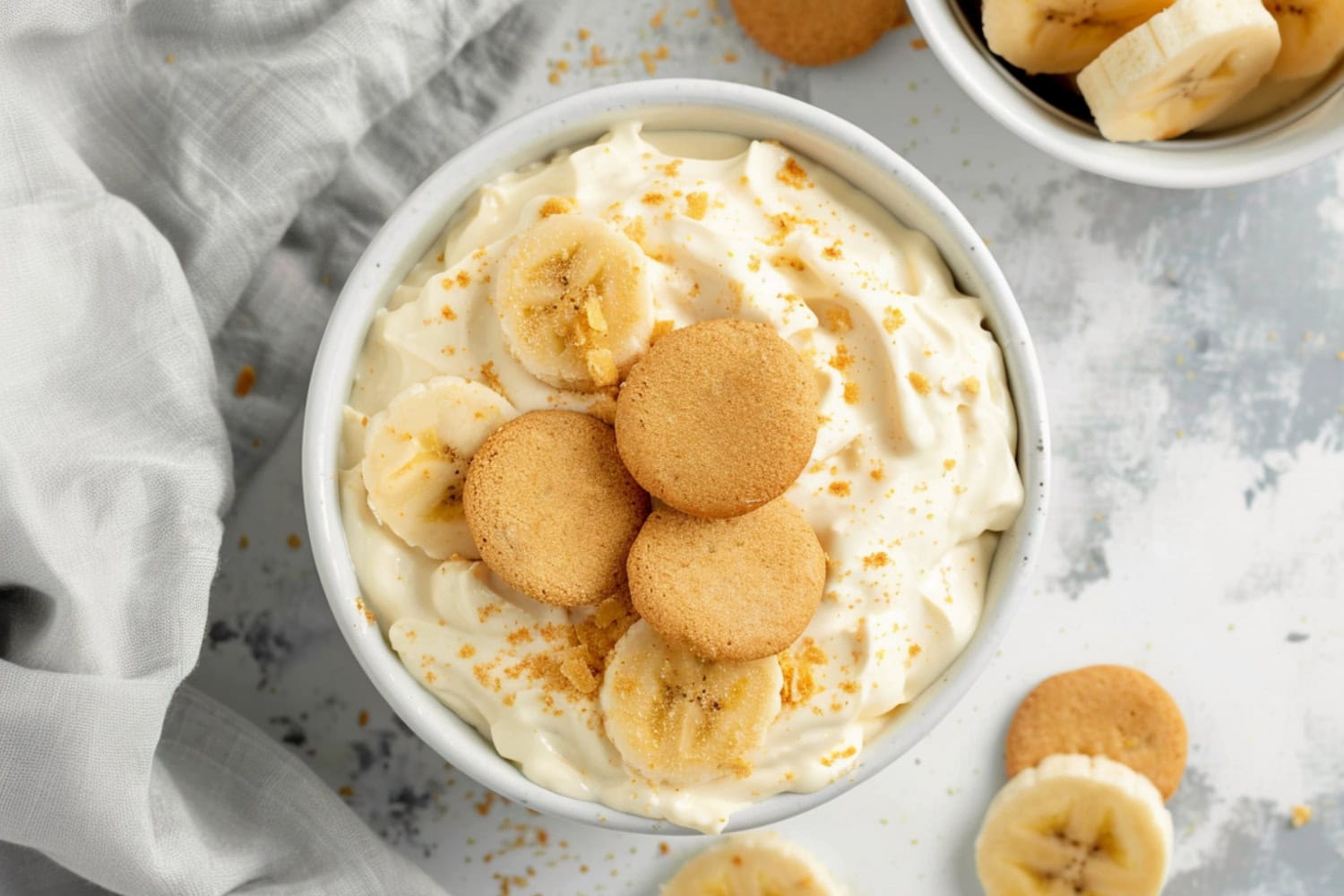 A close-up shot of banana pudding dip highlighting the creamy consistency with three vanilla wafers on top