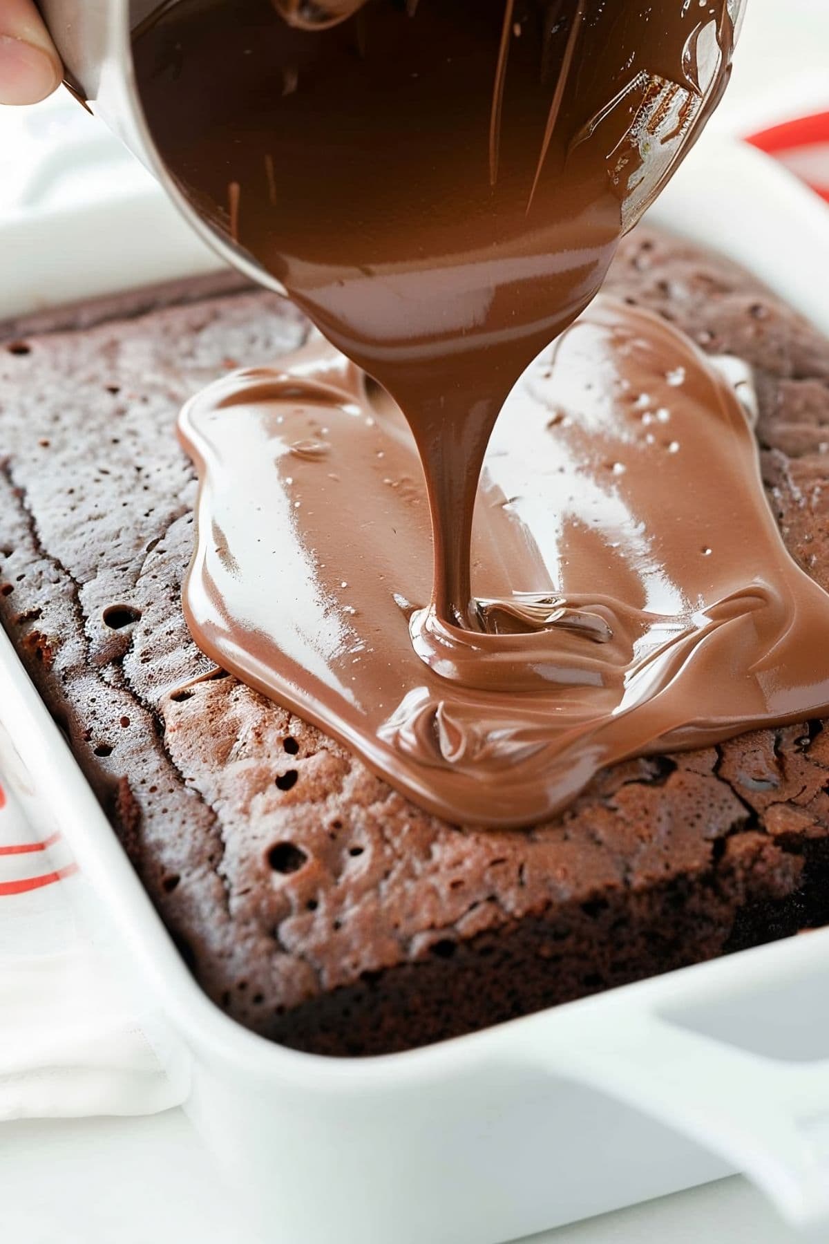 Close Up of Pouring Chocolate Frosting onto Baked Coca Cola Cake