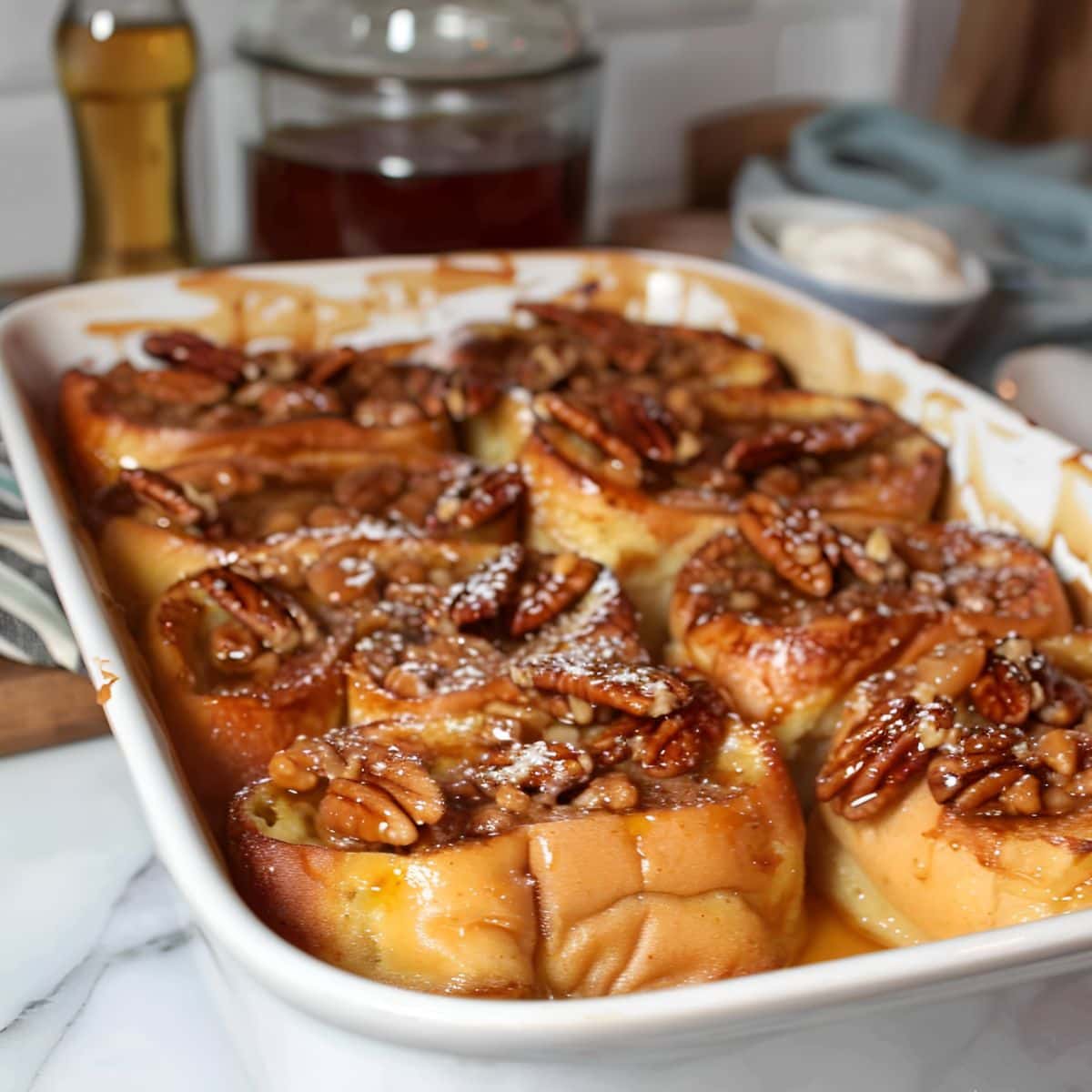 Paula Deen's French Toast in a White Casserole Dish with Pecan Praline Topping