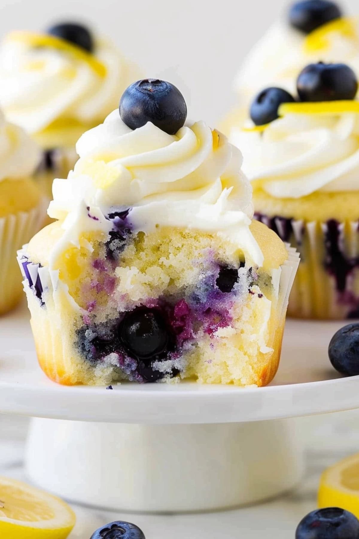 Portion missing lemon blueberry cupcake.