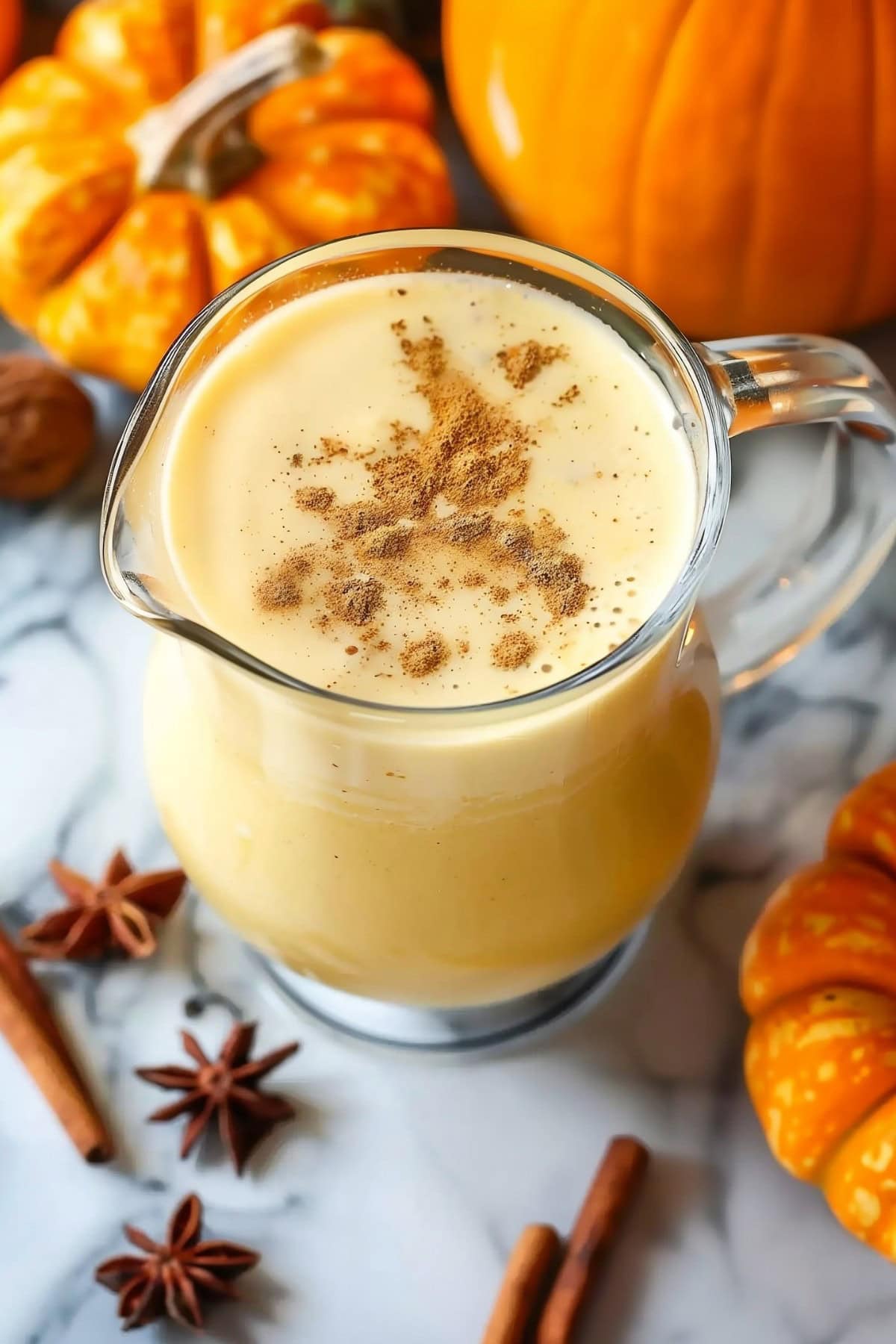 Homemade pumpkin eggnog in a pitcher glass, made with eggs, puree and half-and-half