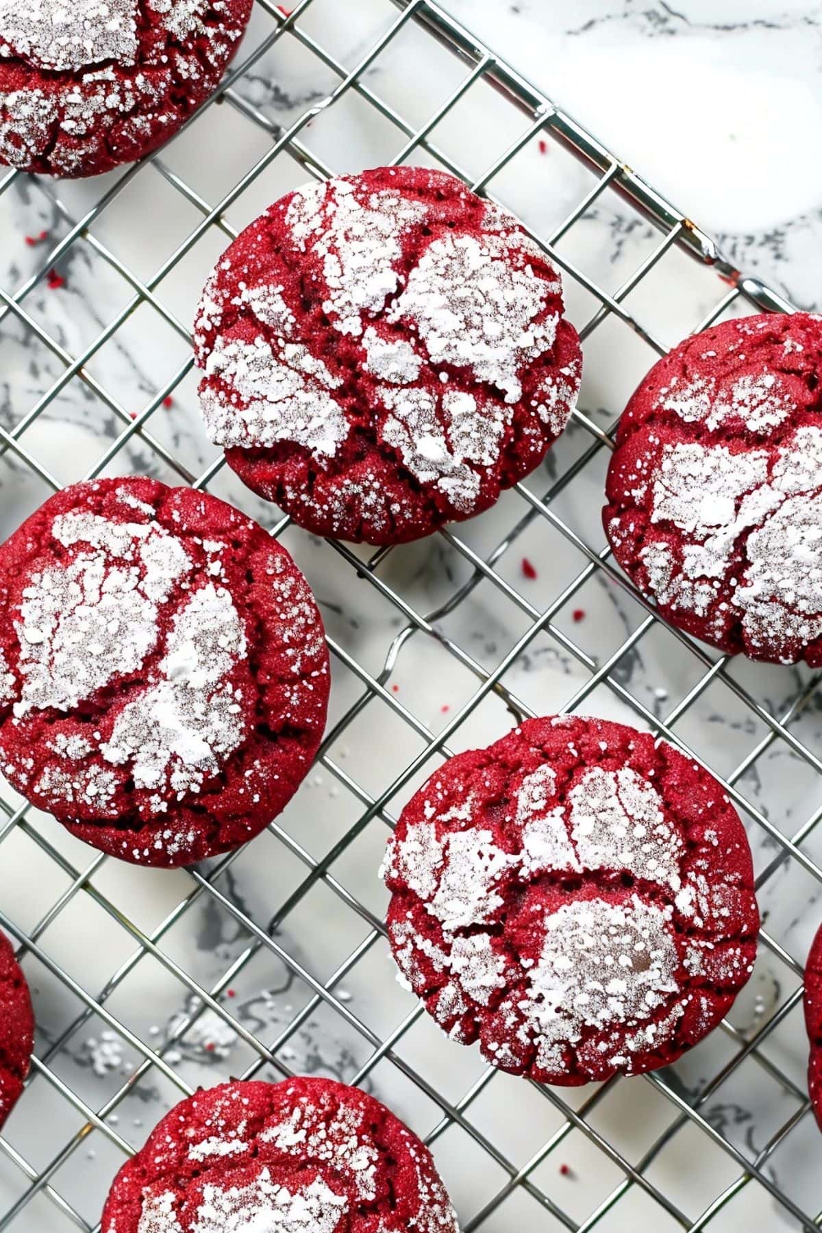 Top View of Red Velvet Crinkle Cookies with Powdered Sugar Dusting on a Wire Rack