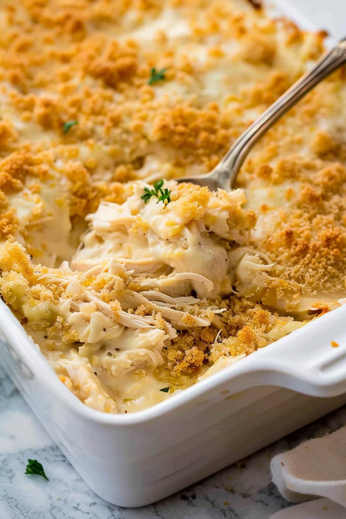 Chicken casserole on a baking dish topped with crushed Ritz crackers.