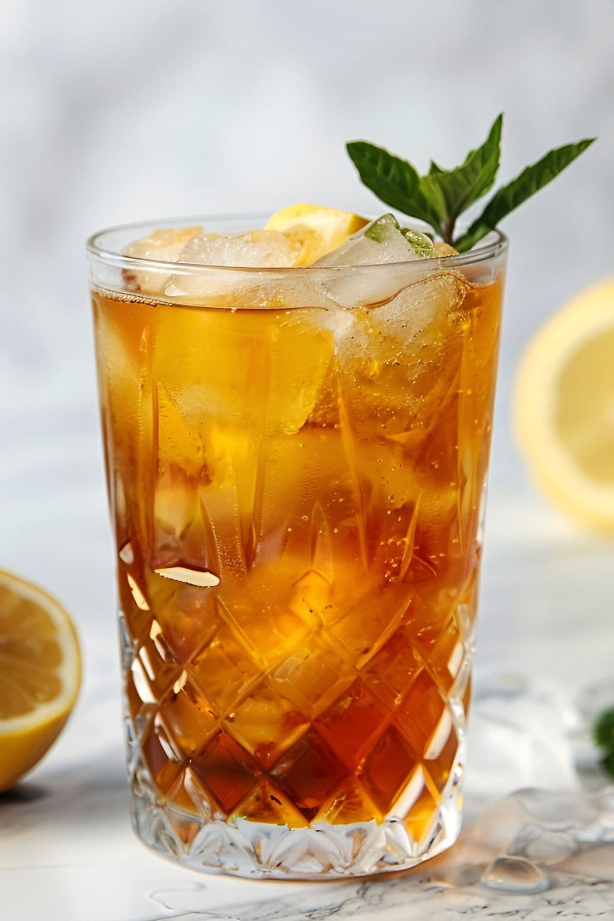 Tall, Cold, and Refreshing Glass of Sun Tea with Ice, Lemon, and Mint