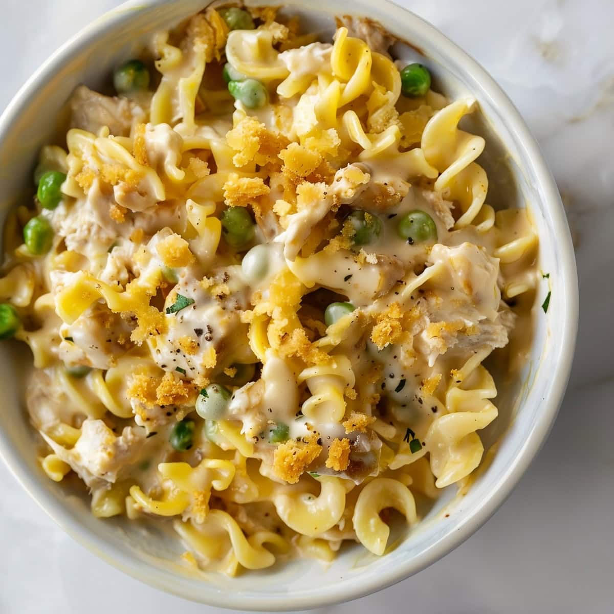 A serving of creamy tuna noodle casserole topped with crispy breadcrumbs.