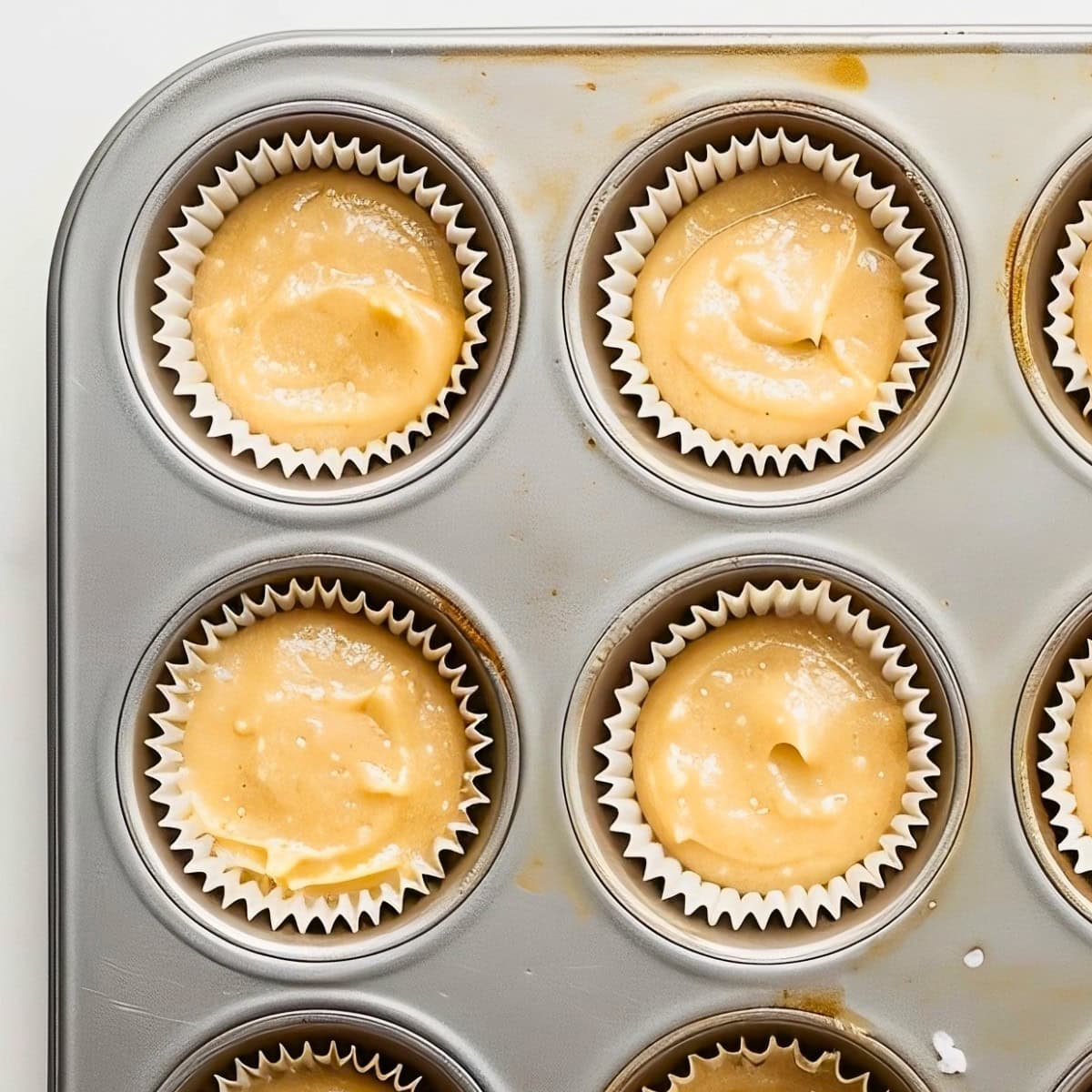 Banana Nut Muffin Batter in Muffin Liners in a Muffin Tin