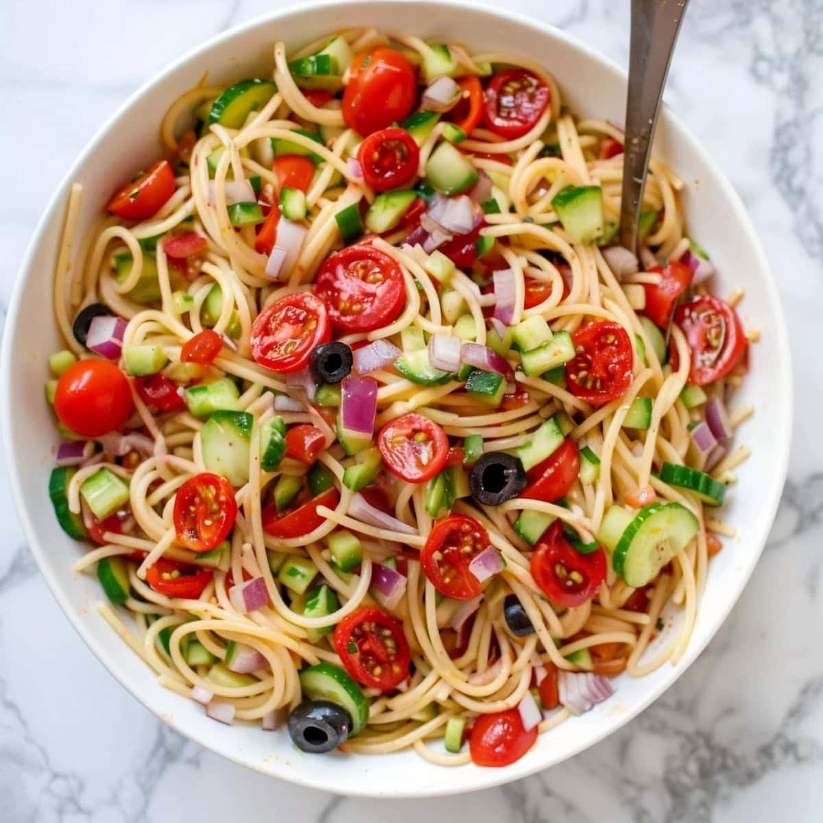Delicious California pasta salad, tossed with cherry tomatoes, red onions and black olives.