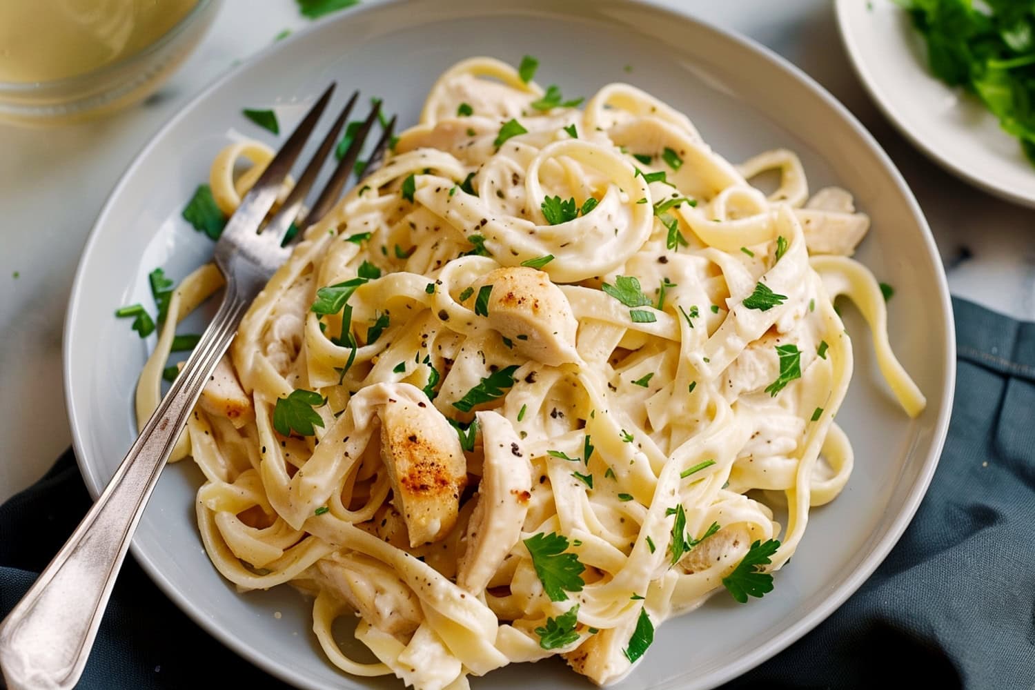 Creamy pasta, featuring tender chicken strips and fettuccine in a rich alfredo sauce.