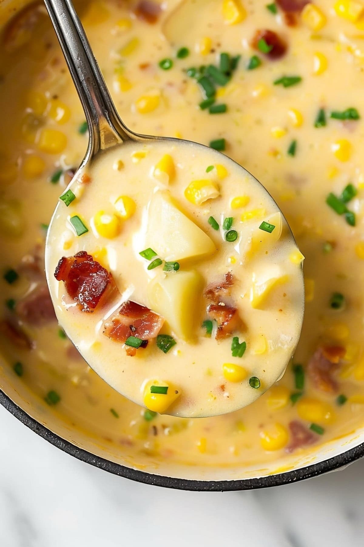 Savory corn chowder, with chunks of potatoes, bacon, chives and a creamy, buttery broth.