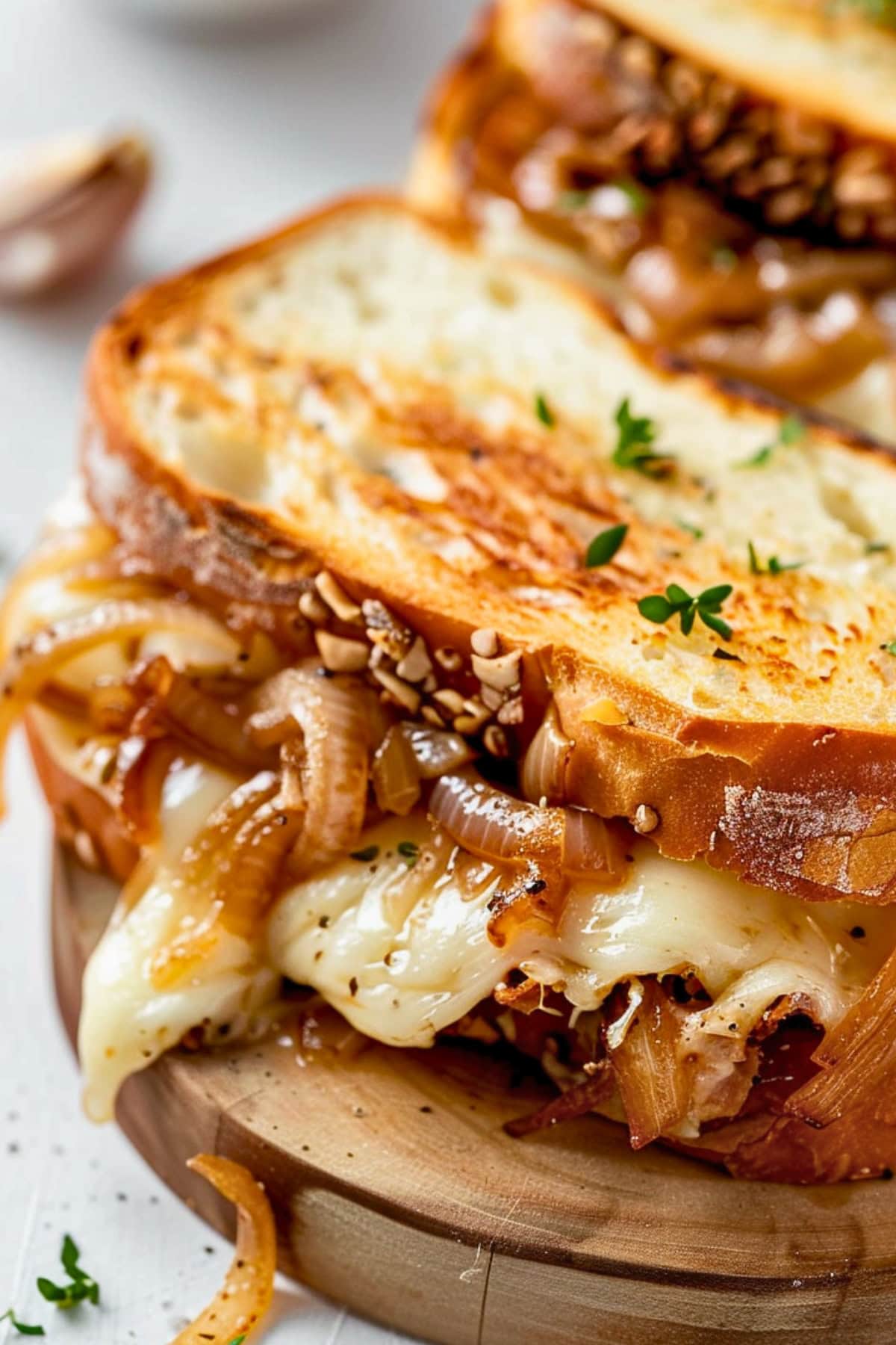 Close up of a French Onion Grilled Cheese Sandwich on a chopping board